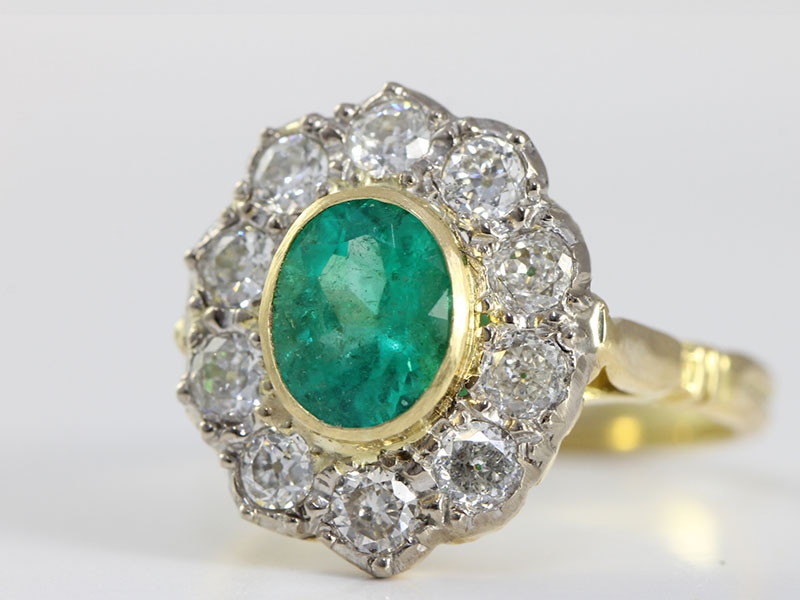  A MESMERISING EMERALD AND DIAMOND CLUSTER 18 CARAT GOLD RING