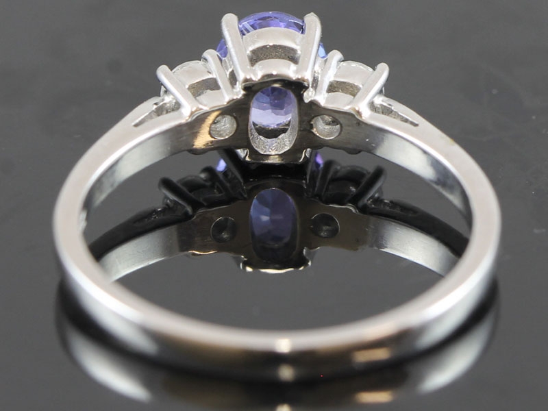 STYLISH TANZANITE AND DIAMOND TRILOGY 18 CARAT GOLD RING