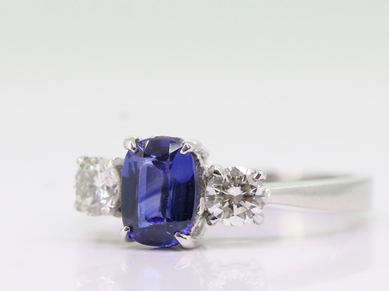 STUNNING CEYLON SAPPHIRE AND DIAMOND 18 CARAT GOLD TRILOGY RING