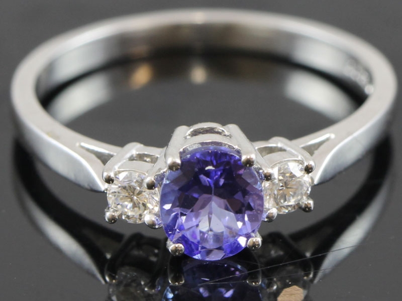 STYLISH TANZANITE AND DIAMOND TRILOGY 18 CARAT GOLD RING