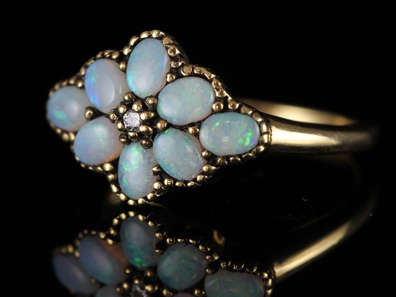 A VERY PRETTY  9 CARAT GOLD OPAL AND DIAMOND FLOWER RING