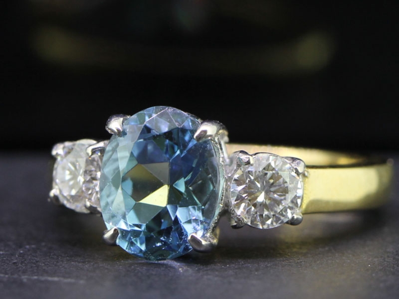 BREATHTAKING AQUAMARINE AND DIAMOND TRILOGY 18 CARAT GOLD RING