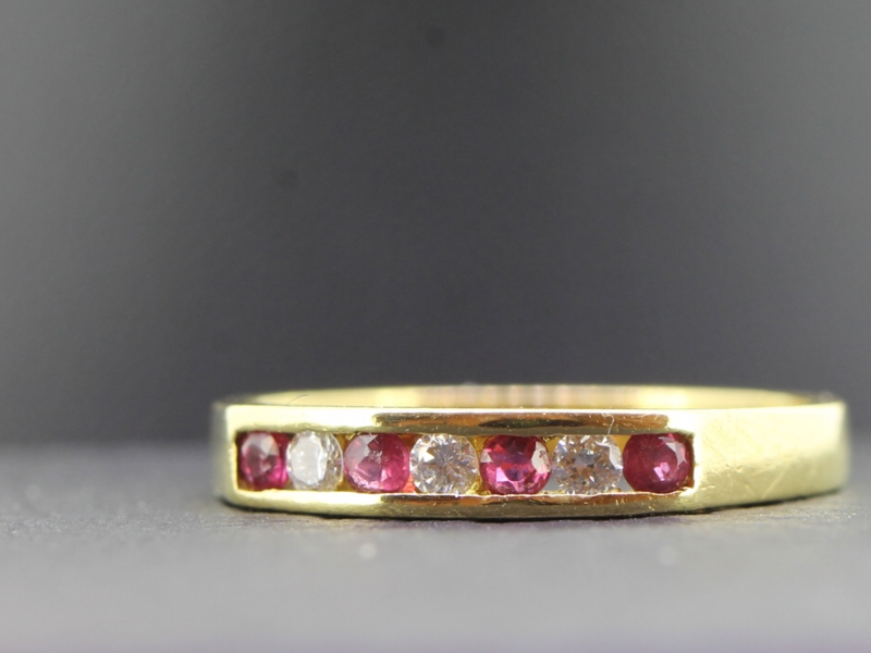 LOVELY RUBY AND DIAMOND HALF ETERNITY 18 CARAT GOLD RING