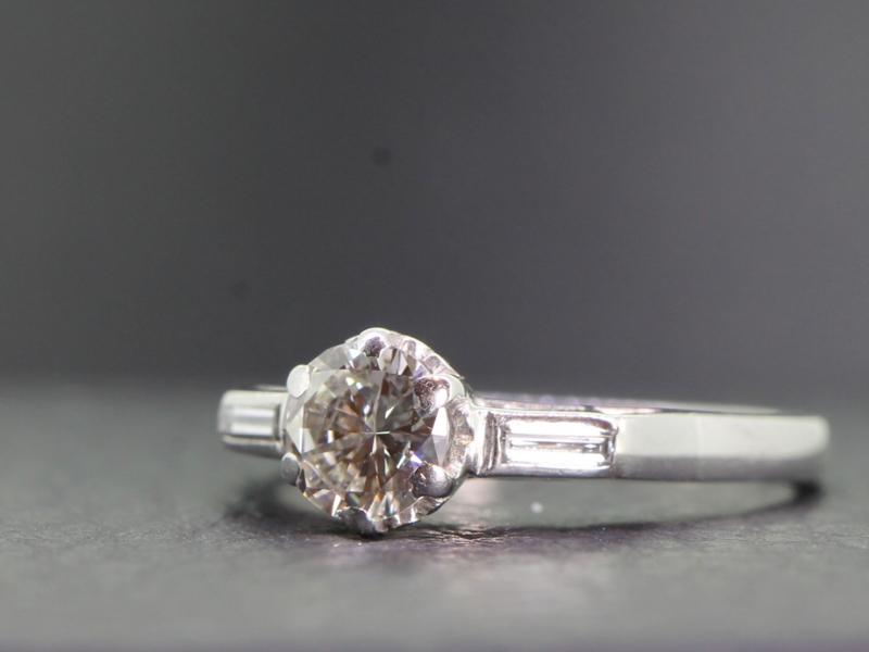 GORGEOUS DIAMOND SOLITAIRE WITH DIAMOND BAGUETTE SHOULDERS CRAFTED IN PLATINUM