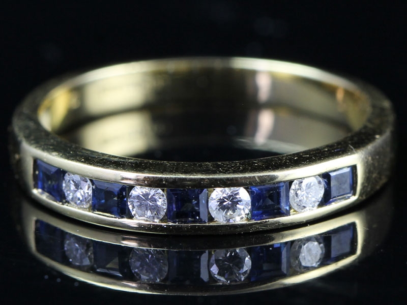 STRIKING DIAMOND AND SAPPHIRE 18 CARAT GOLD HALF ETERNITY RING