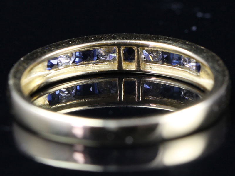 STRIKING DIAMOND AND SAPPHIRE 18 CARAT GOLD HALF ETERNITY RING
