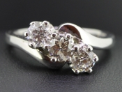   IMPRESSIVE THREE STONE DIAMOND ON A TWIST IN 18 CARAT GOLD