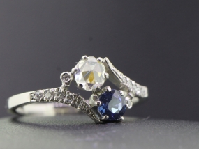 ELEGANT TWO STONE DIAMOND AND SAPPHIRE PLATINUM RING ON A TWIST