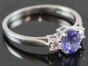 STYLISH TANZANITE AND DIAMOND TRILOGY 18 CARAT GOLD RING