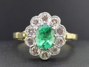 STUNNING EMERALD AND DIAMOND 18 CARAT GOLD CLUSTER RING