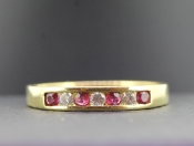 LOVELY RUBY AND DIAMOND HALF ETERNITY 18 CARAT GOLD RING