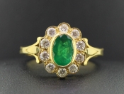 TANTALISING COLUMBIAN EMERALD AND DIAMOND 18 CARAT GOLD HALO CLUSTER