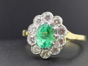 STUNNING EMERALD AND DIAMOND 18 CARAT GOLD CLUSTER RING