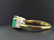 ENCHANTING EMERALD AND DIAMOND 18 CARAT GOLD TRILOGY RING
