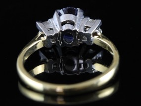 A REGAL SAPPHIRE AND DIAMOND TRILOGY 18 CARAT GOLD RING