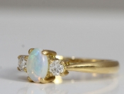 STYLISH OPAL AND DIAMOND TRILOGY 18 CARAT GOLD RING