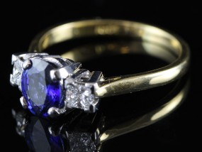 A REGAL SAPPHIRE AND DIAMOND TRILOGY 18 CARAT GOLD RING