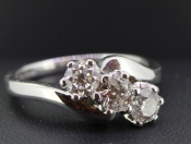   IMPRESSIVE THREE STONE DIAMOND ON A TWIST IN 18 CARAT GOLD