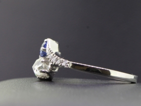 ELEGANT TWO STONE DIAMOND AND SAPPHIRE PLATINUM RING ON A TWIST