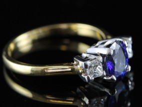 A REGAL SAPPHIRE AND DIAMOND TRILOGY 18 CARAT GOLD RING