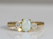 STYLISH OPAL AND DIAMOND TRILOGY 18 CARAT GOLD RING