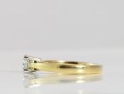A CLASSIC ROUND BRILLIANT CUT SOLITAIRE DIAMOND RING IN 18 CARAT GOLD