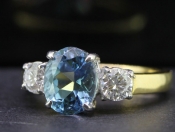 BREATHTAKING AQUAMARINE AND DIAMOND TRILOGY 18 CARAT GOLD RING