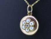 PRETTY ROUND 15 CARAT GOLD SEED PEARL AND DIAMOND LOCKET