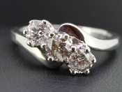   IMPRESSIVE THREE STONE DIAMOND ON A TWIST IN 18 CARAT GOLD