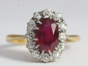  A DAZZLING RUBY AND DIAMOND 18 CARAT GOLD CLUSTER RING