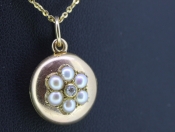 PRETTY ROUND 15 CARAT GOLD SEED PEARL AND DIAMOND LOCKET