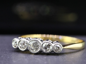 CHARMING FIVE STONE 18 CARAT GOLD AND PLATINUM RING