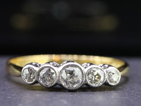 CHARMING FIVE STONE 18 CARAT GOLD AND PLATINUM RING