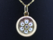 PRETTY ROUND 15 CARAT GOLD SEED PEARL AND DIAMOND LOCKET