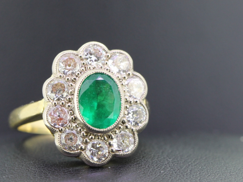 Elegant emerald and diamond 18 carat gold cluster ring 