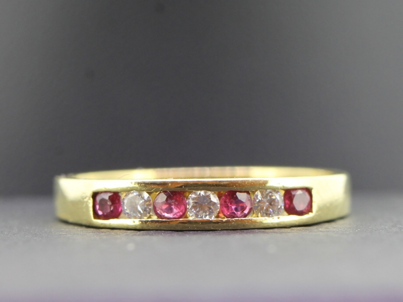 Lovely ruby and diamond half eternity 18 carat gold ring