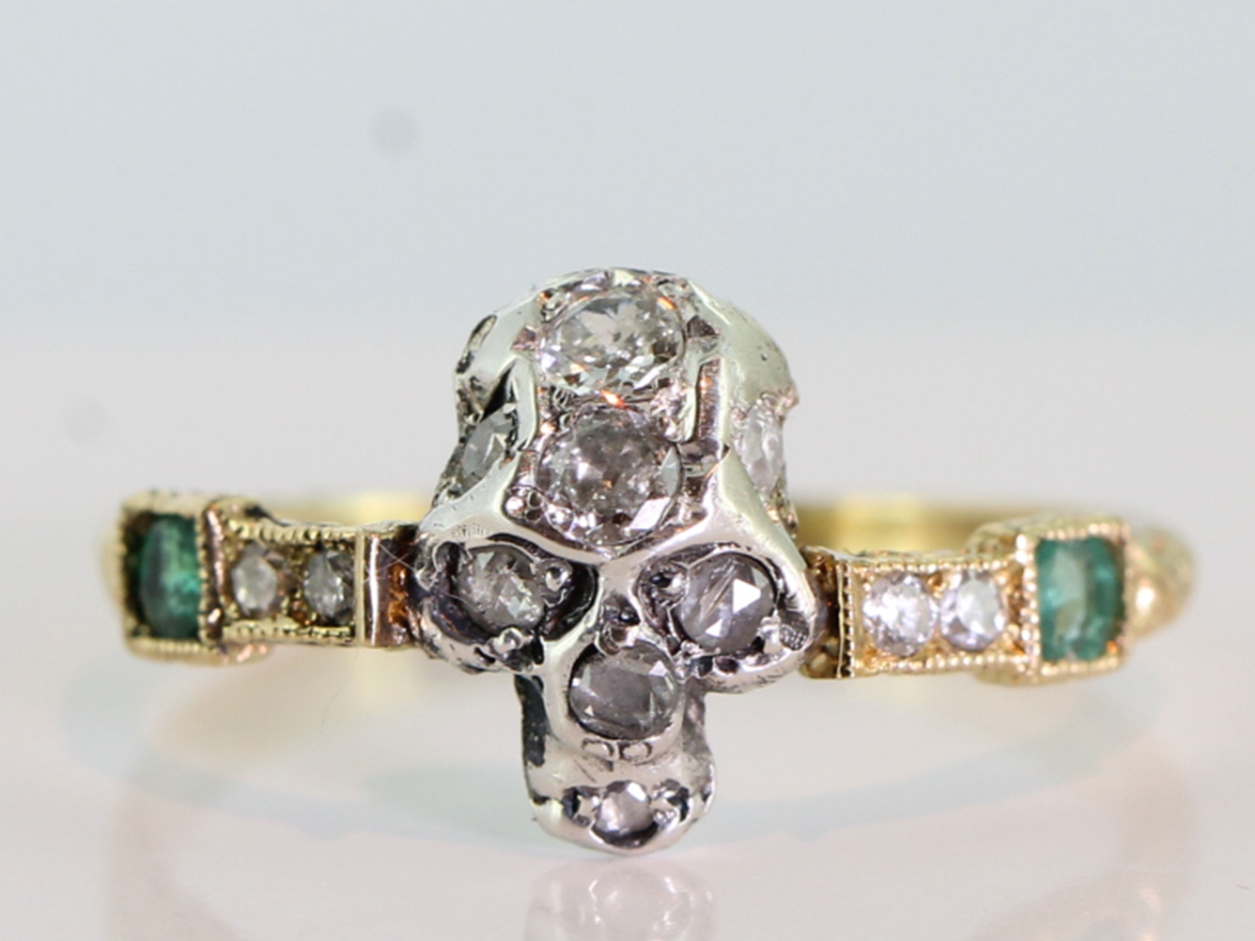 Wonderful diamond set silver skull and emerald and diamond 18 carat gold mourning ring