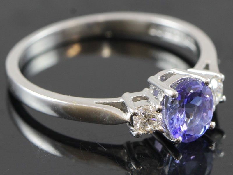 Stylish tanzanite and diamond trilogy 18 carat gold ring