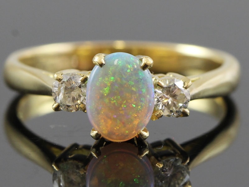 Beautiful opal and diamond trilogy 18 carat gold ring