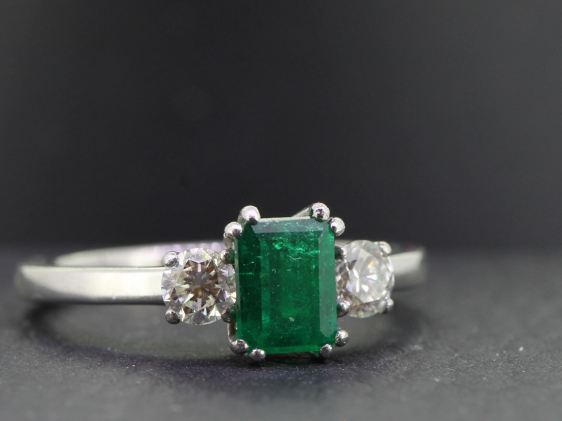 Luxurious colombian emerald and diamond platinum trilogy ring