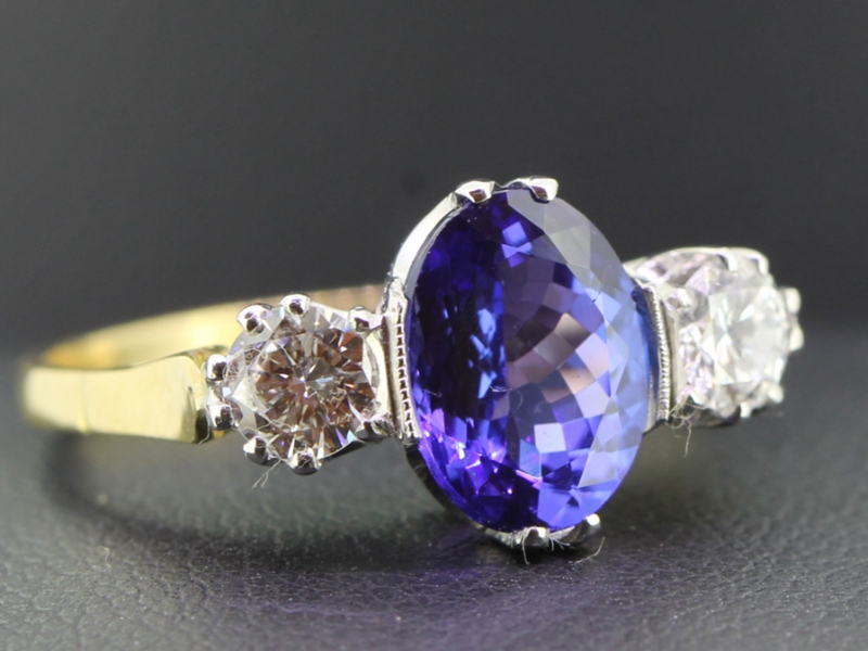  striking tanzanite and diamond 18 carat gold trilogy ring