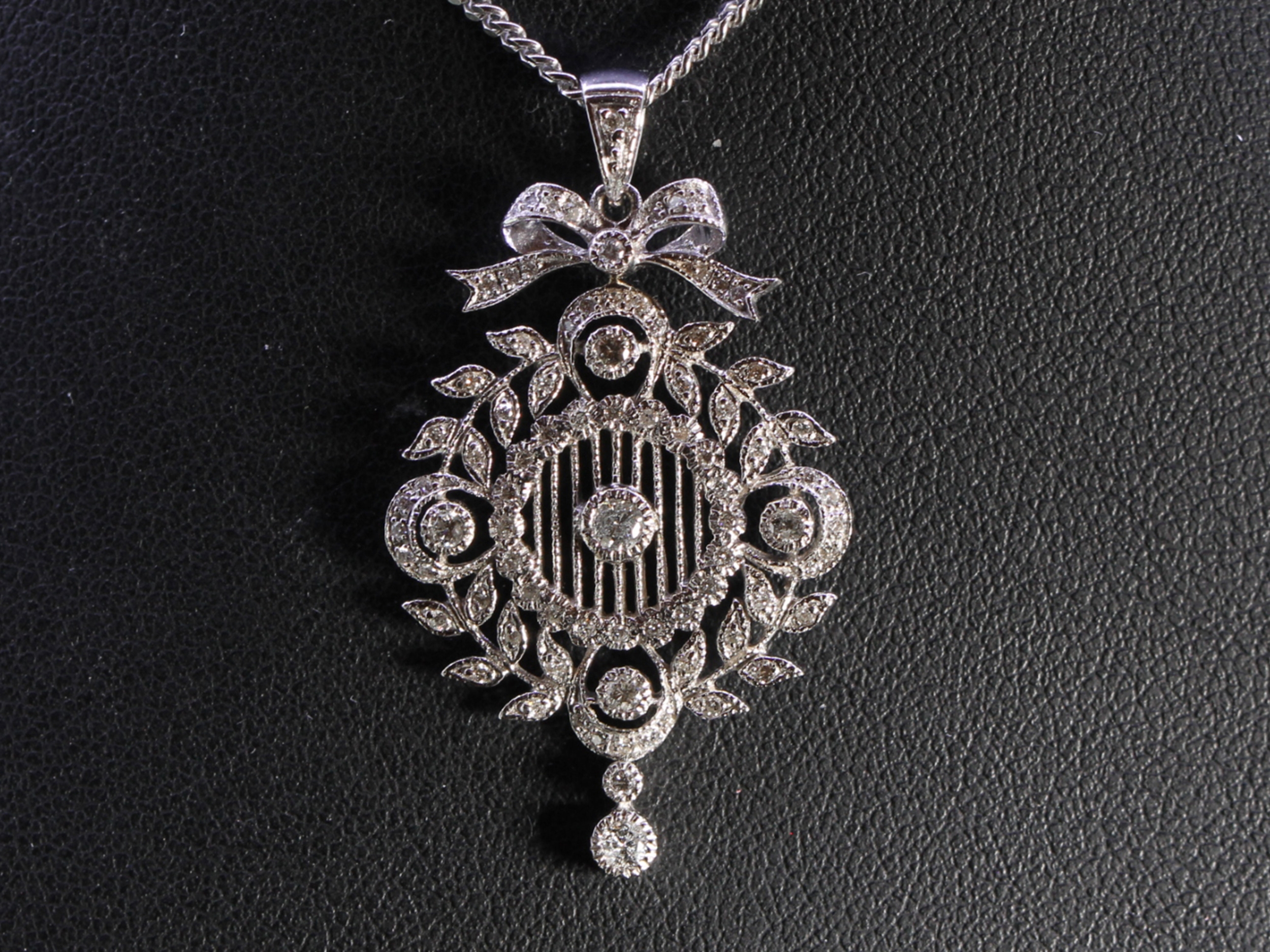 Vintage circular diamond set garland floral 18ct gold pendant