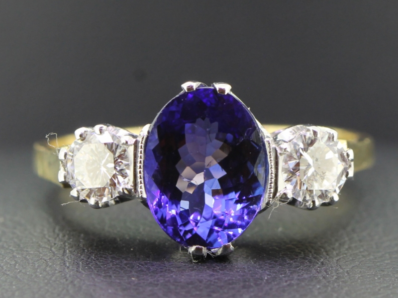  striking tanzanite and diamond 18 carat gold trilogy ring