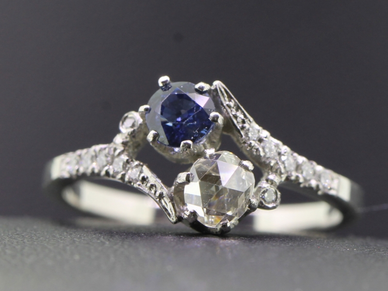 Elegant two stone diamond and sapphire platinum ring on a twist