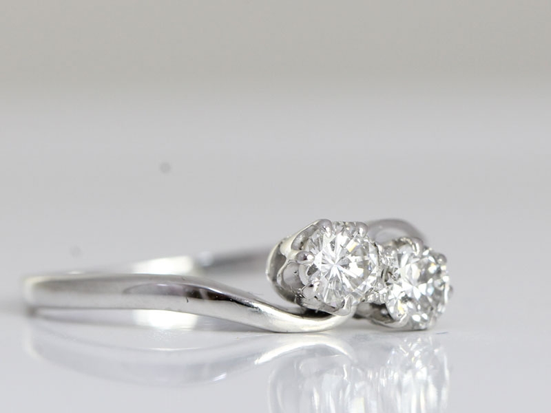 Beautiful two stone diamond on a twist 18 carat gold ring