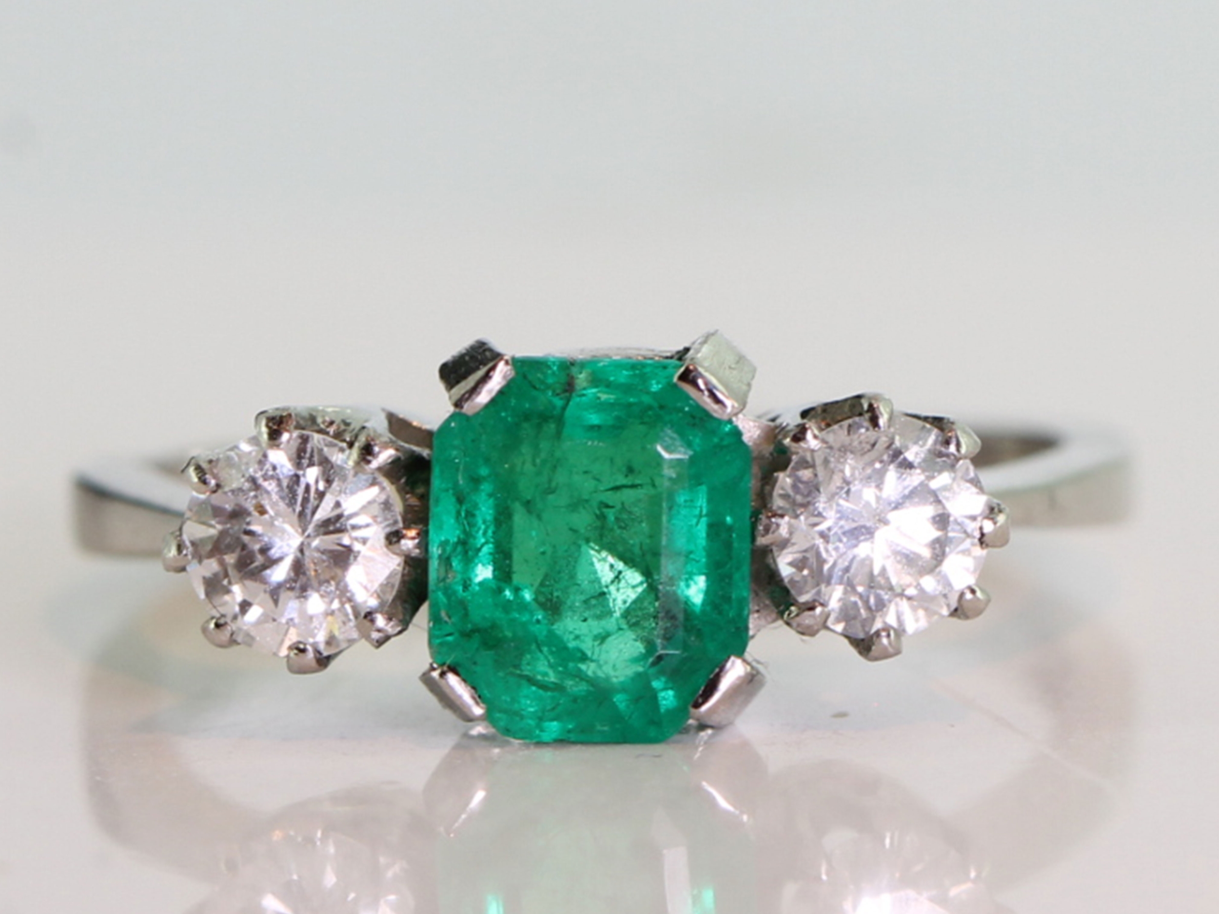 Beautiful emerald and diamond platinum trilogy ring
