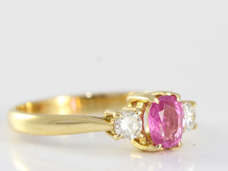 Enchanting pink sapphire and diamond 18 carat gold trilogy ring
