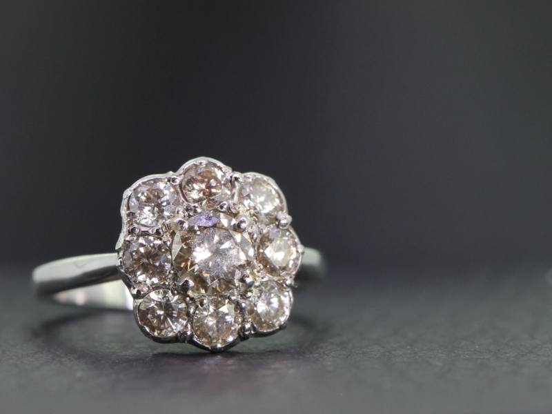 Stunning cinnamon nine stone diamond daisy platinum cluster ring