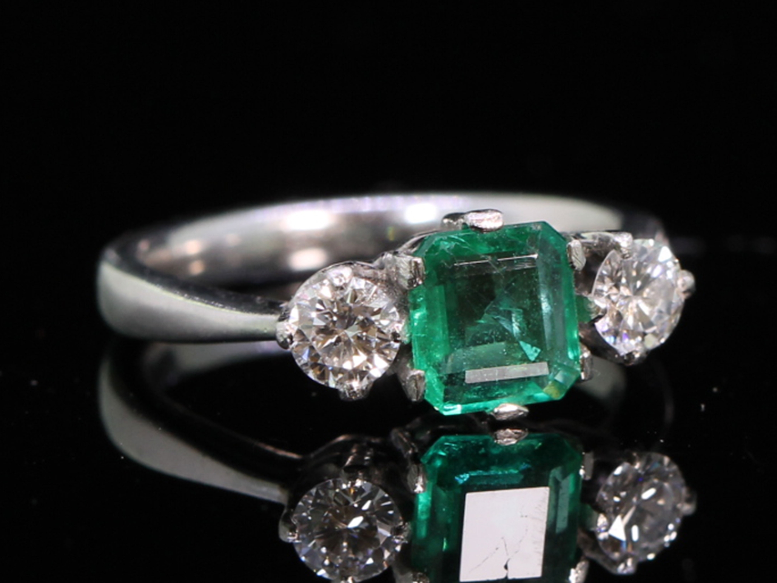 Vintage emerald and diamond trilogy platinum ring