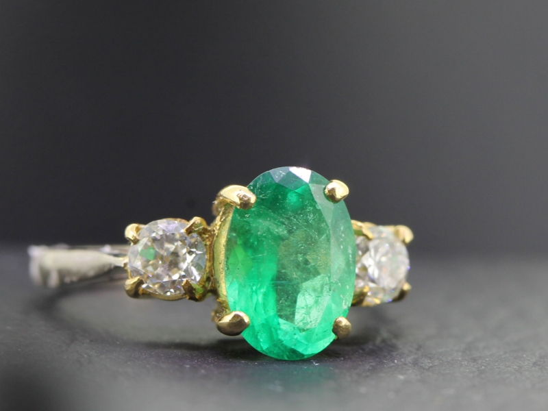 A stylish three stone colombian emerald and diamond 18 carat gold ring
